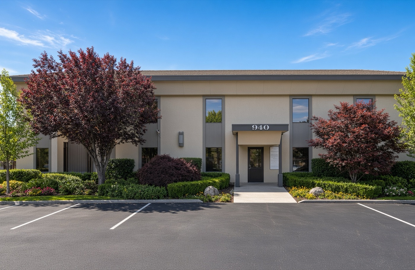 The two-story office building at 940 Saratoga Avenue in San Jose with its front parking lot
